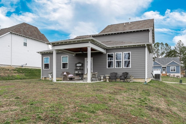 back of property with a ceiling fan, central AC unit, a yard, and a patio area