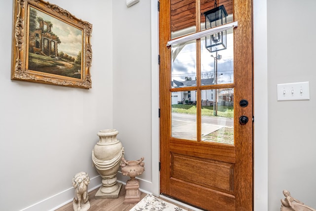 doorway featuring baseboards