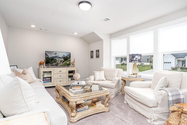 living area featuring visible vents, recessed lighting, and carpet