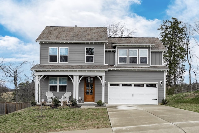 view of front of home with a front yard, covered porch, concrete driveway, fence, and a garage