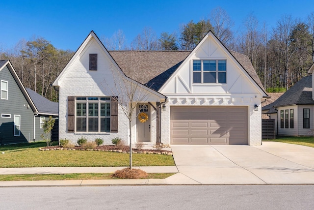 view of front facade featuring brick siding, a shingled roof, a front yard, a garage, and driveway