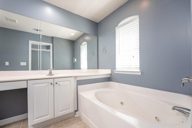 full bathroom featuring vanity, a tub with jets, tile patterned flooring, and visible vents