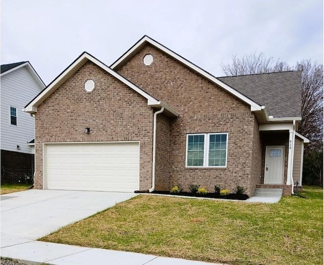 ranch-style home with a garage, concrete driveway, roof with shingles, a front yard, and brick siding