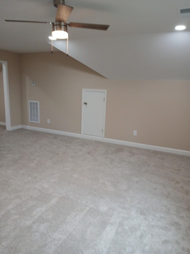 unfurnished room featuring lofted ceiling, visible vents, ceiling fan, and baseboards