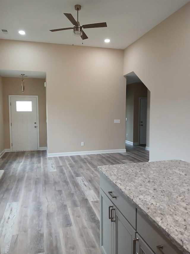 unfurnished living room with light wood-style floors, recessed lighting, and baseboards