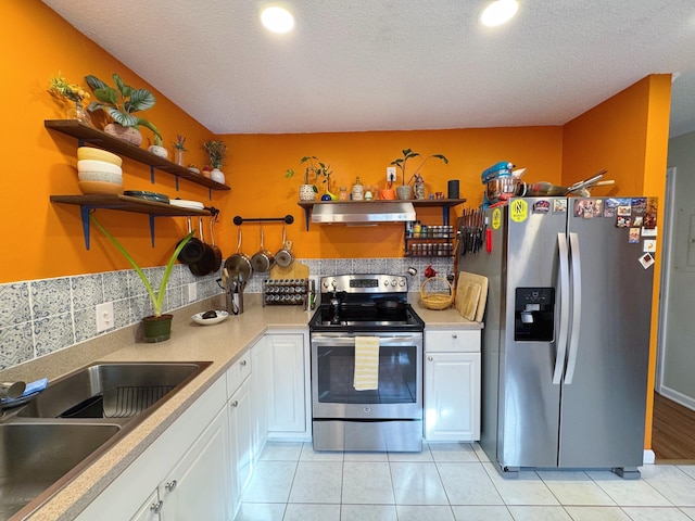 kitchen with open shelves, appliances with stainless steel finishes, white cabinetry, a sink, and ventilation hood