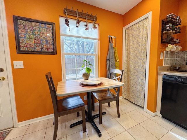 dining space featuring baseboards and light tile patterned floors