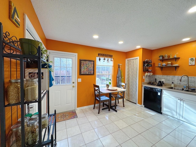 kitchen with black dishwasher, open shelves, tasteful backsplash, light tile patterned floors, and a sink