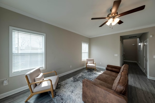 living room with wood finished floors, visible vents, and baseboards