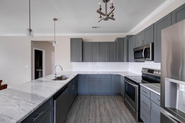 kitchen with a sink, visible vents, ornamental molding, appliances with stainless steel finishes, and light stone countertops