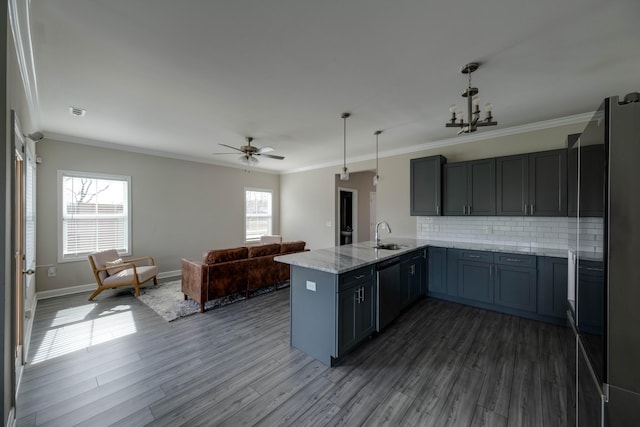 kitchen with dark wood-type flooring, freestanding refrigerator, crown molding, and a peninsula