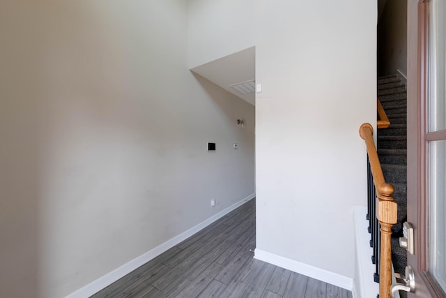 empty room featuring visible vents, stairs, baseboards, and wood finished floors