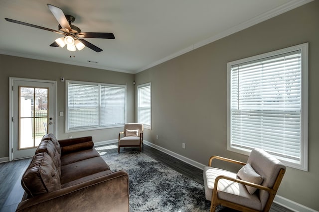 living room featuring crown molding, wood finished floors, and a healthy amount of sunlight