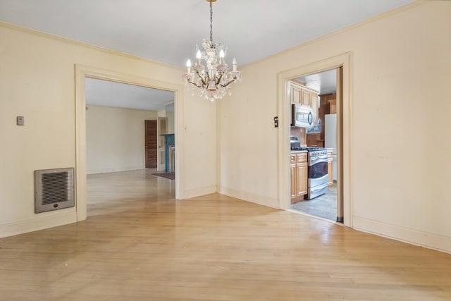 unfurnished dining area featuring heating unit, light wood finished floors, and ornamental molding