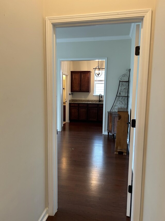 1012 Wooden Gate Dr, Franklin, TN 37064 - hall with crown molding, dark wood-style flooring, a chandelier, and baseboards