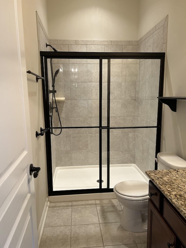 1012 Wooden Gate Dr, Franklin, TN 37064 - full bathroom featuring toilet, vanity, a shower stall, and tile patterned floors