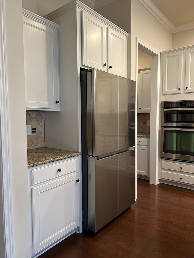 1012 Wooden Gate Dr, Franklin, TN 37064 - kitchen with stainless steel appliances, crown molding, light stone countertops, backsplash, and white cabinets