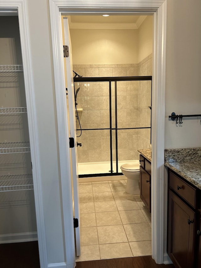 1012 Wooden Gate Dr, Franklin, TN 37064 - bathroom with vanity, toilet, a stall shower, tile patterned flooring, and crown molding