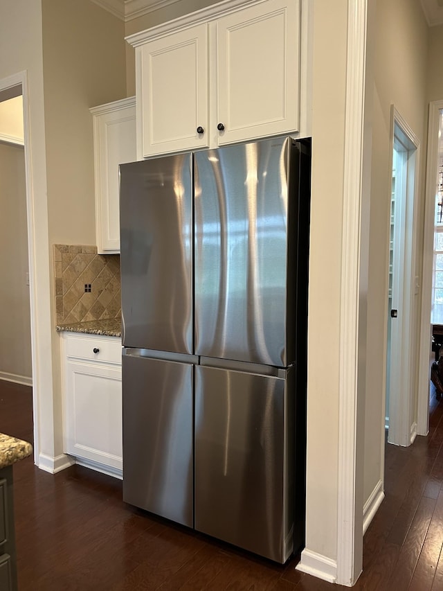 1012 Wooden Gate Dr, Franklin, TN 37064 - kitchen with freestanding refrigerator, dark wood-style floors, light stone countertops, baseboards, and white cabinetry