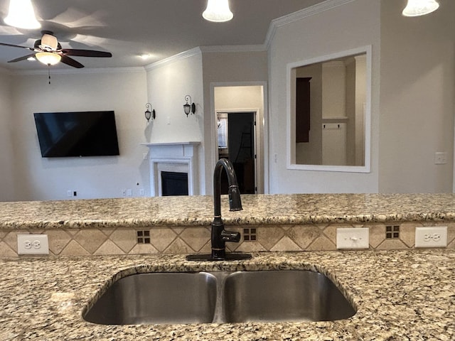 1012 Wooden Gate Dr, Franklin, TN 37064 - kitchen with a sink, light stone countertops, ceiling fan, crown molding, and open floor plan