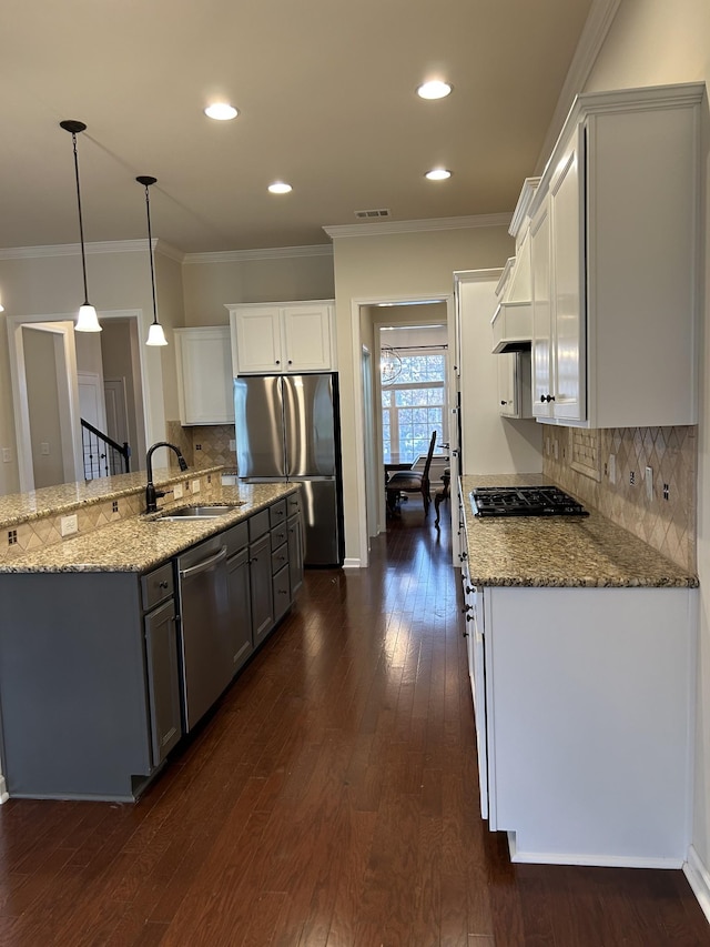 1012 Wooden Gate Dr, Franklin, TN 37064 - kitchen with stainless steel appliances, a sink, dark wood finished floors, light stone countertops, and decorative backsplash