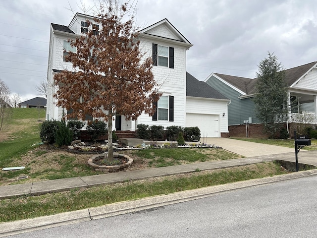 1012 Wooden Gate Dr, Franklin, TN 37064 - view of front facade with a garage, driveway, and a front lawn