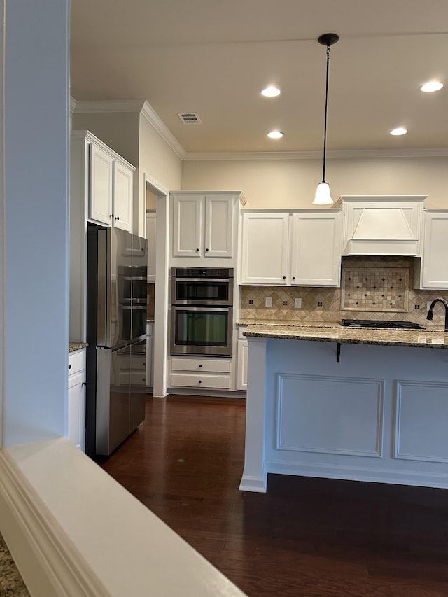1012 Wooden Gate Dr, Franklin, TN 37064 - kitchen with appliances with stainless steel finishes, crown molding, custom range hood, white cabinetry, and tasteful backsplash