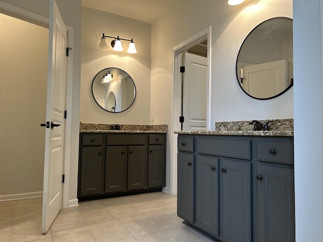 1012 Wooden Gate Dr, Franklin, TN 37064 - full bathroom with two vanities, tile patterned flooring, and baseboards