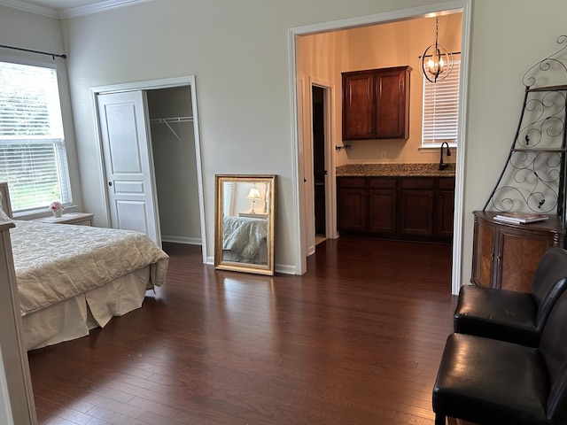 1012 Wooden Gate Dr, Franklin, TN 37064 - bedroom featuring crown molding, dark wood-style flooring, a closet, a chandelier, and baseboards