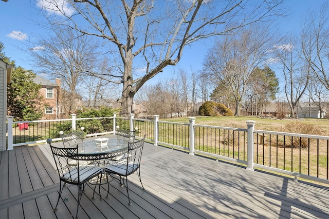 wooden terrace featuring outdoor dining area