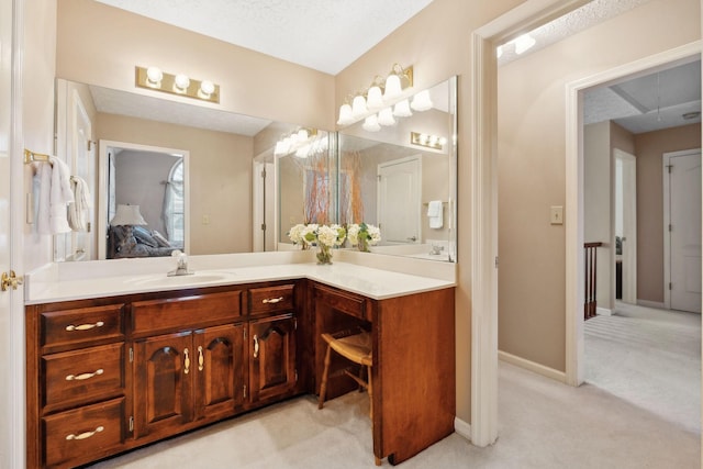 bathroom featuring ensuite bathroom, vanity, and baseboards