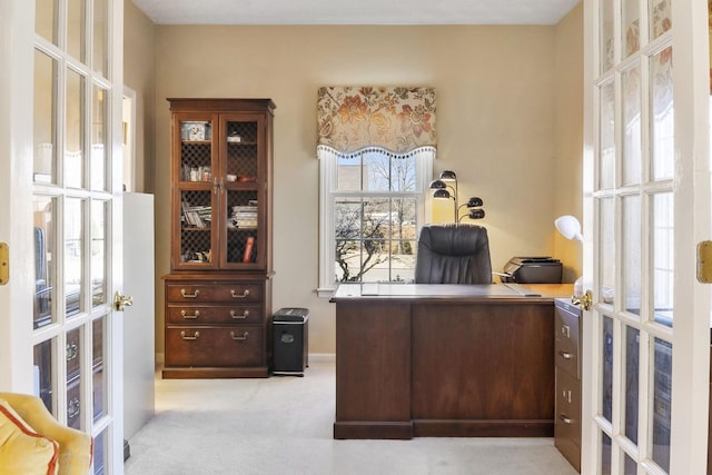 carpeted office featuring french doors