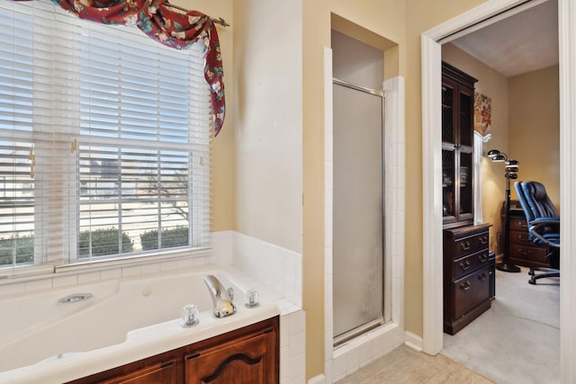 bathroom with a shower stall and a bath