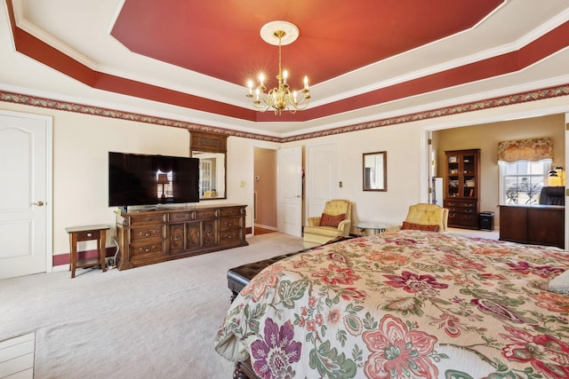 bedroom featuring ornamental molding, a tray ceiling, a notable chandelier, and carpet