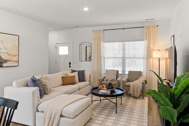 living room with light wood-style flooring and recessed lighting