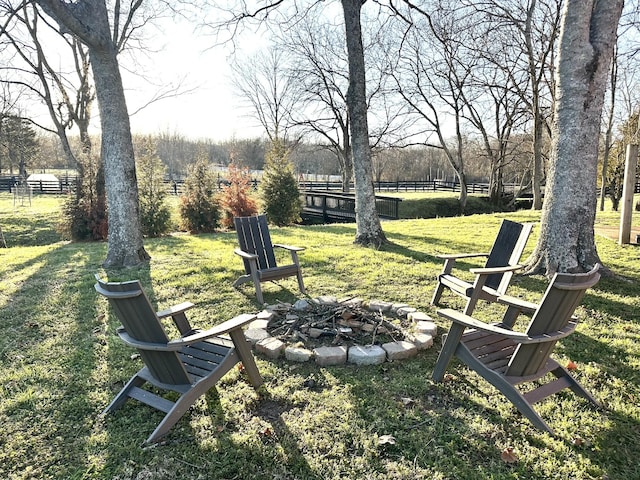 view of yard featuring a fire pit and fence