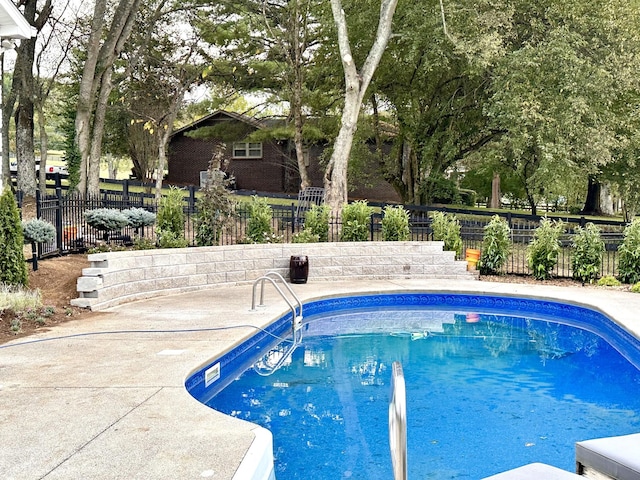 view of pool featuring a fenced in pool, a patio area, and fence