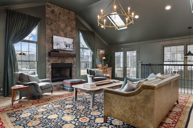 living area with a stone fireplace, a notable chandelier, vaulted ceiling, french doors, and crown molding