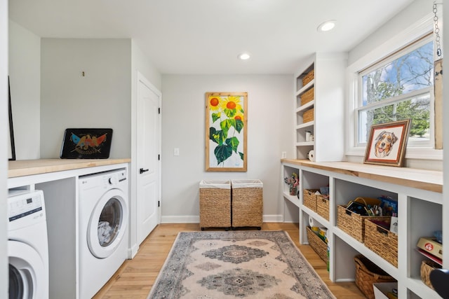 laundry room featuring recessed lighting, light wood-style floors, separate washer and dryer, laundry area, and baseboards