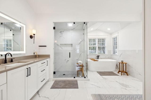 full bath with a marble finish shower, marble finish floor, vanity, a freestanding tub, and recessed lighting