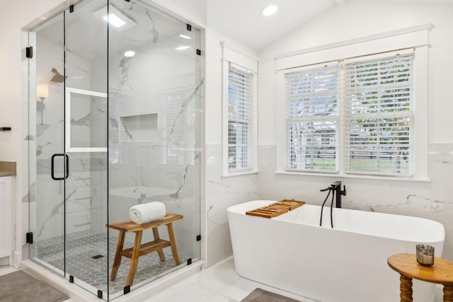 bathroom with marble finish floor, a marble finish shower, lofted ceiling, recessed lighting, and a freestanding bath