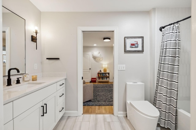 bathroom featuring toilet, shower / tub combo, baseboards, and vanity