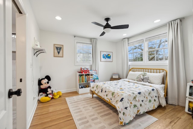 bedroom with light wood-style floors, baseboards, and recessed lighting