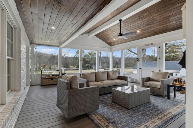 sunroom / solarium featuring a healthy amount of sunlight, wooden ceiling, ceiling fan, and vaulted ceiling with beams