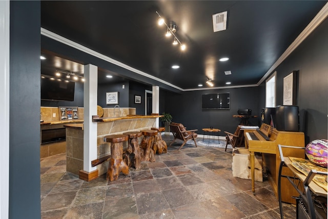 interior space with visible vents, baseboards, stone finish floor, ornamental molding, and recessed lighting