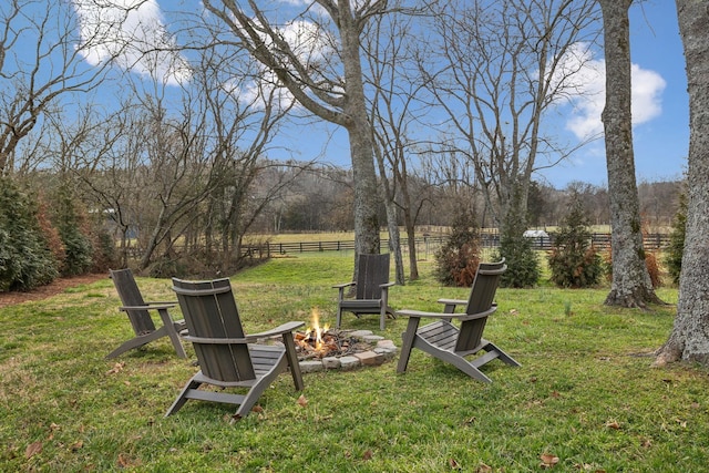 view of yard with an outdoor fire pit and fence