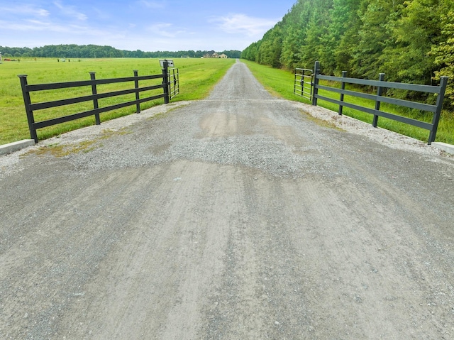 view of road featuring driveway and a rural view