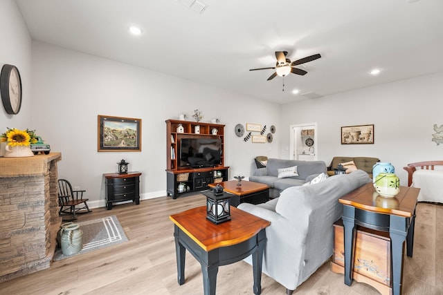 living area with light wood-type flooring, ceiling fan, visible vents, and recessed lighting