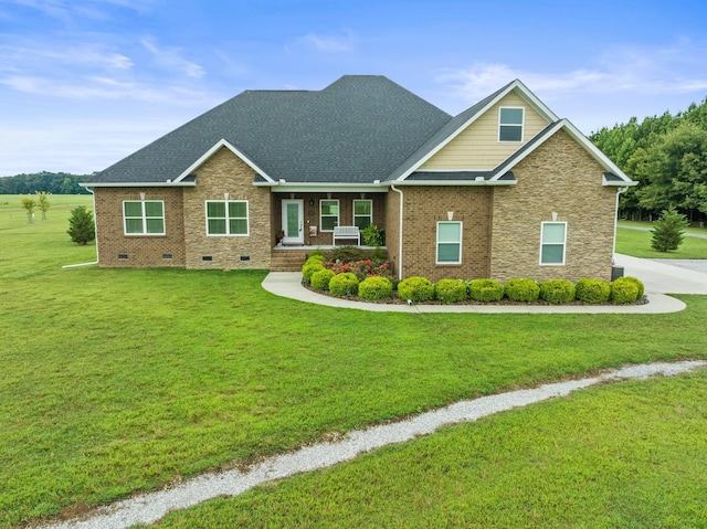 craftsman inspired home with roof with shingles, a front lawn, crawl space, and brick siding