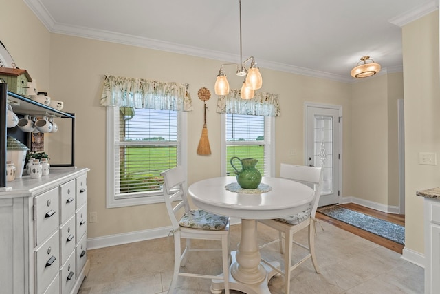 dining room featuring baseboards, a chandelier, and crown molding